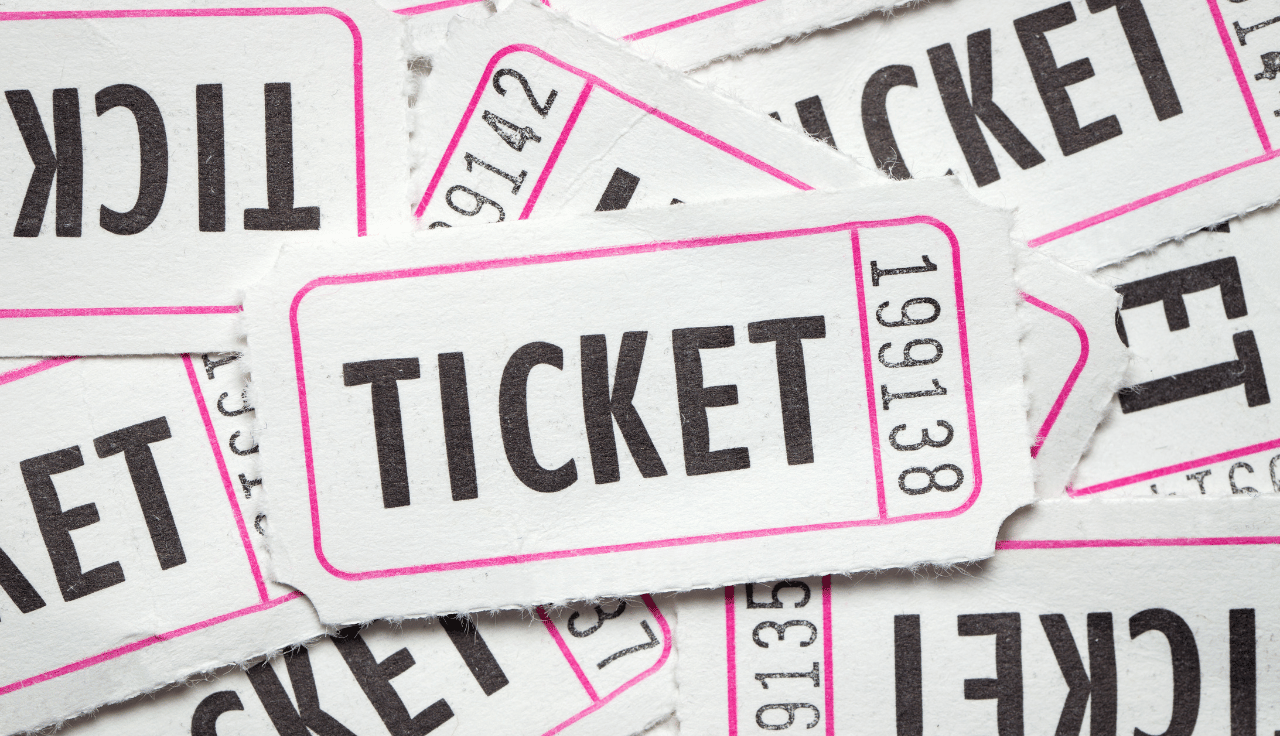 Several admission tickets are visible with the word ticket spelled in black font.